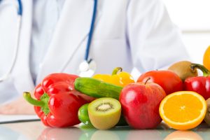 Doctor with fruit and veg f+v doc image - sized as email block - 'donate here'